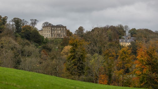 An autumn view of the house from estate walks, Newark Park, Gloucestershire